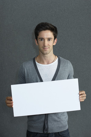 Man holding a blank placardの写真素材