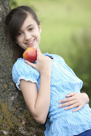 Girl holding an appleの写真素材