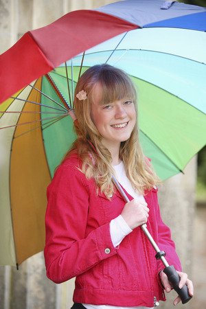 Girl holding a colorful umbrellaの写真素材