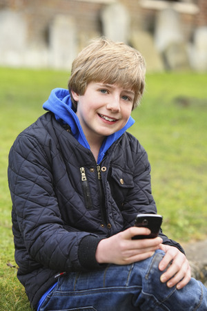 Boy using mobile phoneの写真素材