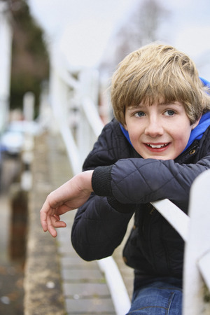 Boy sitting outdoorsの写真素材