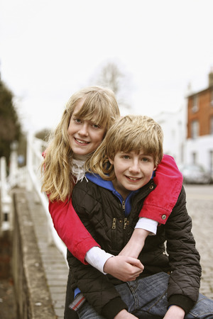 Girl hugging boy from behindの写真素材