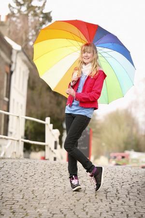 Girl holding a colorful umbrellaの写真素材