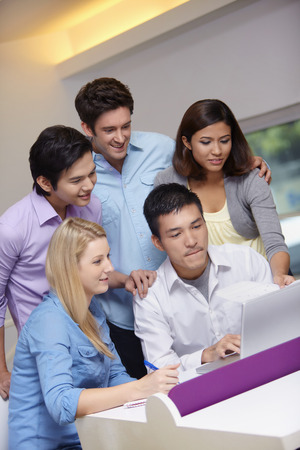 Business people working on the laptop togetherの写真素材