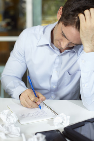 Businessman writing in notebookの写真素材