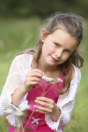 Girl holding small flowersの写真素材