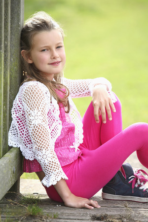 Girl sitting and smiling at the cameraの写真素材