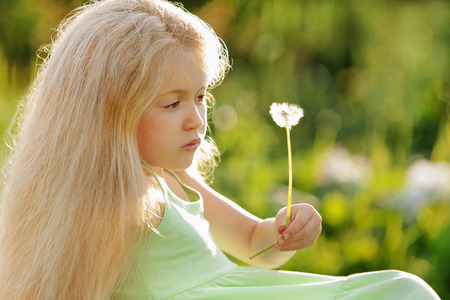 Girl holding a dandelionの写真素材