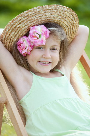 Girl relaxing on a deck chairの写真素材