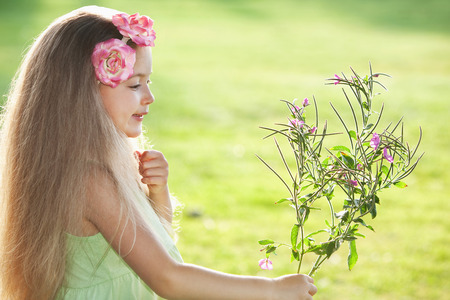 Girl with flowers in her handの写真素材