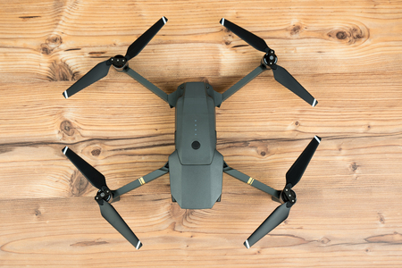 DJI Mavic Pro drone: Riga,Latvia DECEMBER 25,2016. One of the first DJI Mavic Pro drones shipped to Europe. Closeup,on wooden background. One of the most portable drones in the market,with 4k ultra hdのeditorial素材