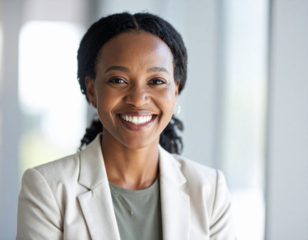 portrait of smiling african american businesswoman at modern officeの素材