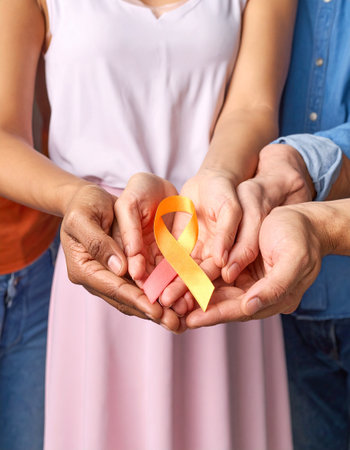 Hands of family with awareness ribbon on light background, closeupの素材