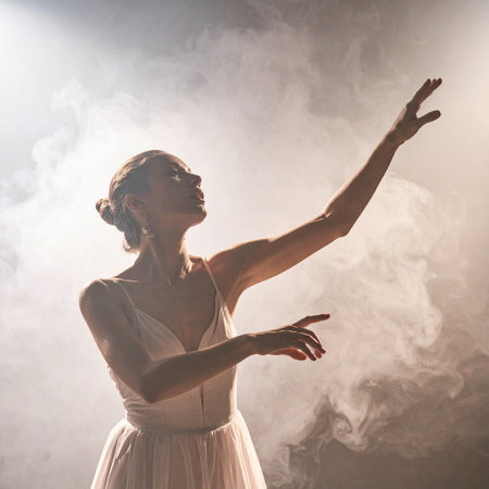Beautiful ballerina in white dress dancing in the smoke.の素材