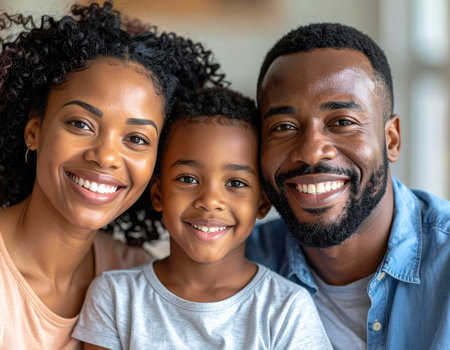 happy african american family looking at camera and smiling at homeの素材