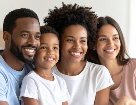 Happy african american family with two children, looking at camera and smiling, close up portraitの素材