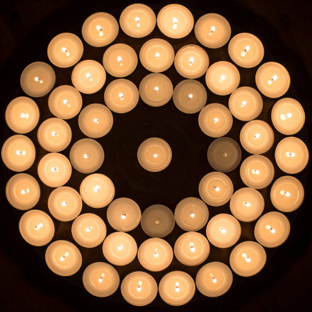 Candles in the shape of a circle on a dark background.の素材