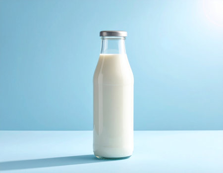 Bottle of milk on blue background. Healthy food concept. Copy spaceの素材
