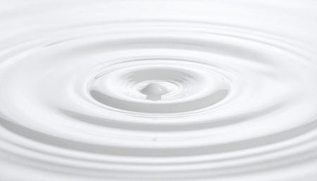 close up of a drop of milk on white background with ripplesの素材