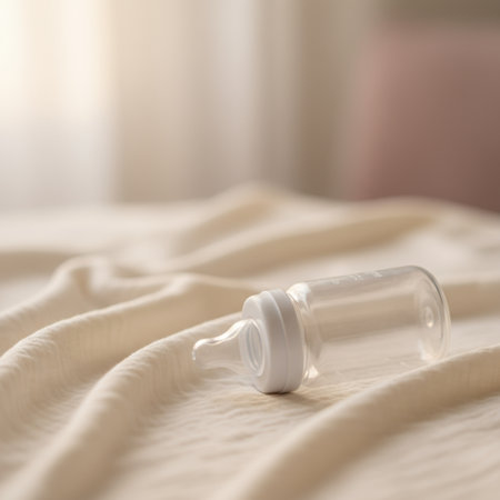 Empty baby bottle on bed. Selective focus. Shallow depth of fieldの素材