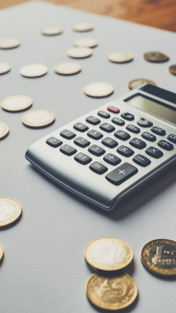 Calculator and coins on the desk, business and finance conceptの素材