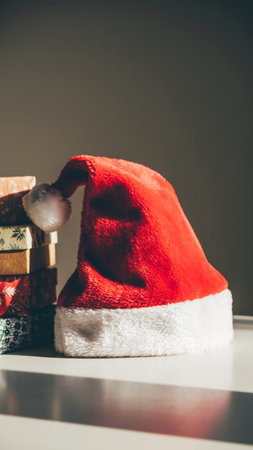 Santa Claus hat and Christmas gifts on the table. Christmas concept.の素材