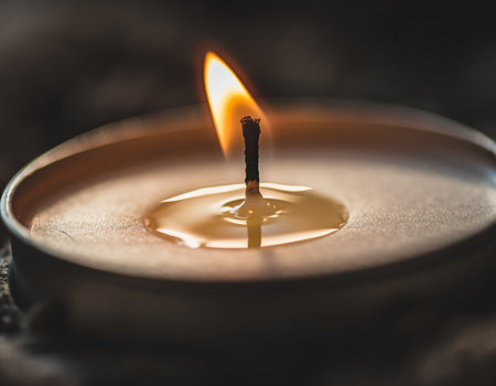 Burning candle on a dark background. Shallow depth of field.の素材