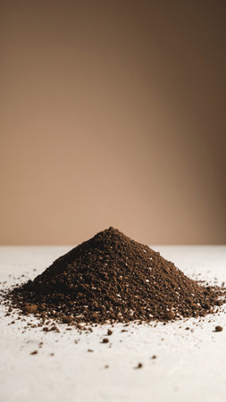 Pile of ground coffee isolated on brown background with copy space.の素材