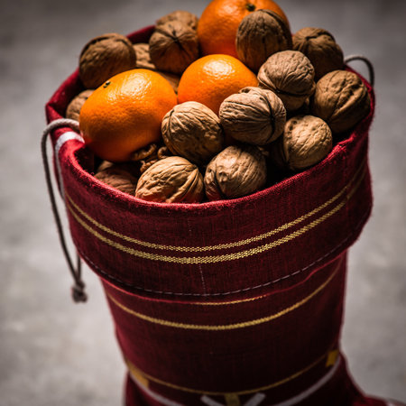 Basket with walnuts and tangerines on a dark backgroundの素材