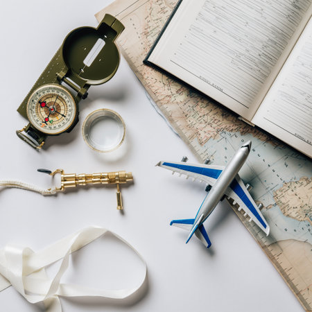 Travel planning concept with airplane, compass, map and notepad on white backgroundの素材