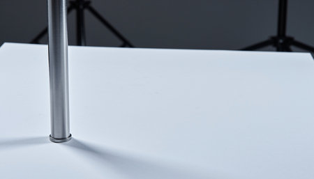 Close-up of a white paper on a stand in a photo studioの素材
