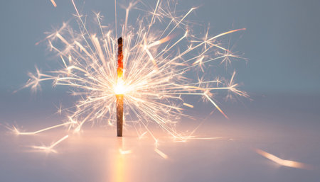 Burning sparkler on white background. New Year and Christmas conceptの素材
