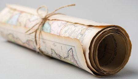 Rolled up old paper map isolated on white background, travel conceptの素材