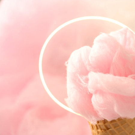 Cotton candy in ice cream cone on pink background, soft focusの素材