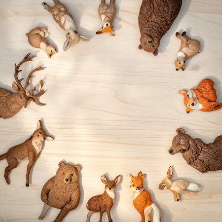 Wooden toys in the form of deer, fox, squirrel, deer on wooden backgroundの素材