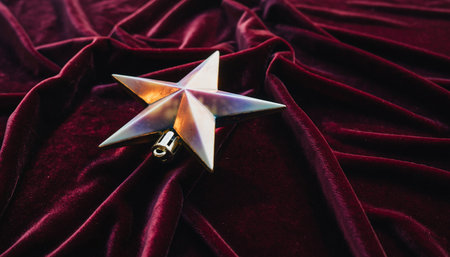 christmas star on red velvet background - soft focus and vintage film filterの素材