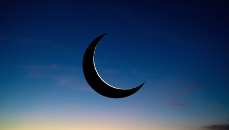 3D Illustration of a Crescent Moon on a Blue Sky Backgroundの素材