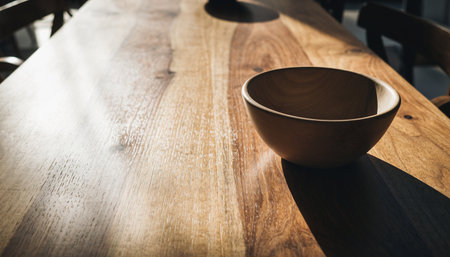 Wooden bowl on wooden table in coffee shop, vintage tone.の素材