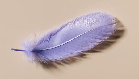 Purple feather on a beige background, close-up.の素材