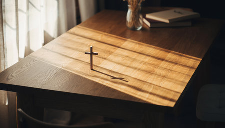 Cross on a wooden table in the room. The concept of religion.の素材