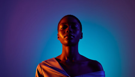 Fashion portrait of young beautiful african american woman in neon light.の素材