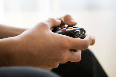 a teenager with a joystick to play video games