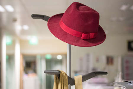A hat is placed on a coat rack in a companyの写真素材