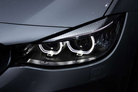 Illustration and close-up on a car headlightの写真素材