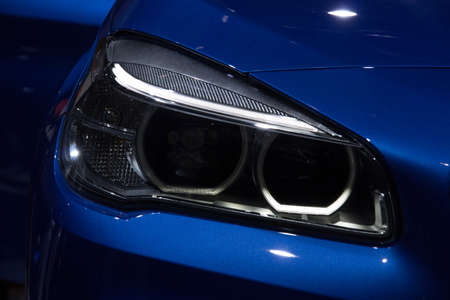 Illustration and close-up on a car headlightの写真素材