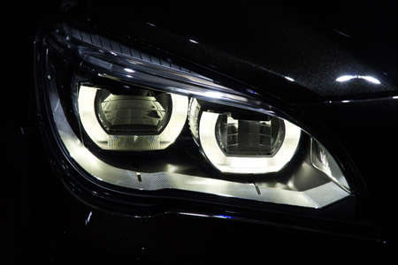 Illustration and close-up on a car headlightの写真素材