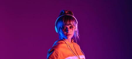 Stylish teen girl wear glasses headphones enjoy listen music, banner.