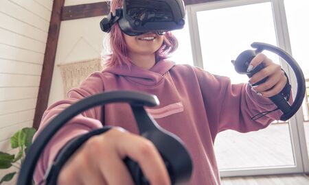 Young adult woman wear vr headset hold controllers play immersive video game.
