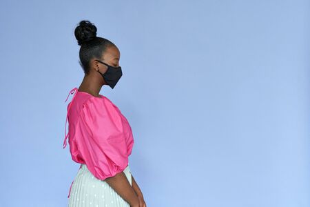 Young african woman wearing stylish trendy black face mask isolated on lilac.の写真素材