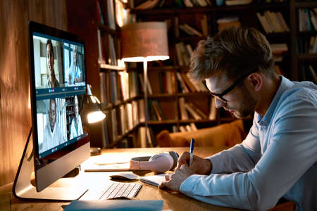 Business man video conference calling on computer working from home office.の写真素材
